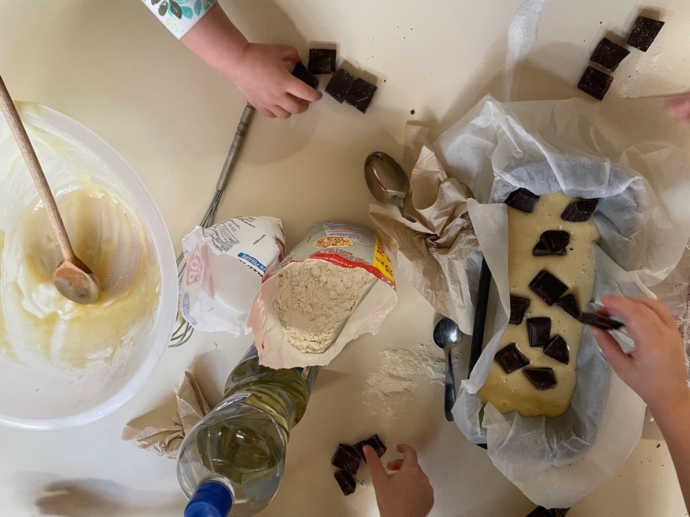 Enfants préparant un gâteau avec des morceaux de chocolat